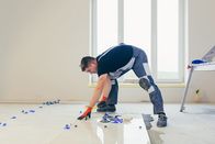 Marktcheck – A male construction worker installs a large ceramic tile