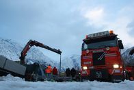 Ice Road Rescue - Extremrettung in Norwegen – EIDFJORD, NORWAY - Bjørn Lægreids tow truck with snowy mountains in the back. Preparing for a boat rescue.