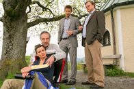 Die Rosenheim-Cops – Die Rosenheimer Kommissare Hansen (Igor Jeftic, 2.v.r.) und Hartl (Tobias A. Grimm, r.) recherchieren im beruflichen Umfeld des Opfers und befragen das Ehepaar Sendlinger (Daniel Friedrich, 2.v.l.; Katja Keller, l.).