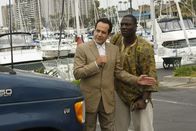 Monk – L-R: Adrian Monk (Tony Shalhoub), Samuel Waingaya (Adewale Akinnuoye-Agbaje )