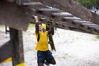 EXATLON Germany – Sportler, die an einem Hindernisparcours teilnehmen, laufen im Freien und kriechen unter der Leiter auf einem Sand. Tragen Sie Trail Laufschuhe mit gutem Griff zum Schutz.