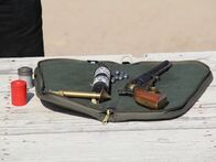 Die Waffensammler – An antique revolver in fantastic condition at the range next to the gunpowder, bullets, and rod used to load it.