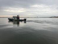 When Sharks Attack - Hai-Alarm – New York State Environmental Conservation Police boat in the Great South Bay with Robert Moses Causeway in the background.