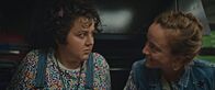 Derby Girl – Marie-Josée (Salomé Diénis Meulien, l.) und Booby Mercury (Allison Chassagne, r.) sitzen in einem Food-Truck. Plötzlich wird der Wagen von einem Polizisten angehalten.