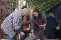 Alaskan Bush People – Billy Brown and Bam Brown serving themselves food. Rain Brown standing with them, Ami Brown behind them.