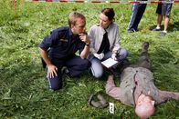Die Rosenheim-Cops – Pathologin Mai (Sina Wilke, r.) klärt Hauptmeister Mohr (Max Müller, l.) über die Todesursache und den Todeszeitpunkt im Mordfall des Försters Denninger (Komparse) auf.