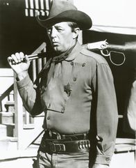 El Dorado – J.P. Harrah (Robert Mitchum), ein ehemaliger Freund des Revolverhelden Cole Thornton (John Wayne, nicht im Bild), ist jetzt Sheriff von El Dorado, einem Ort, in dem sich Schwierigkeiten zusammenbrauen.