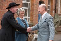 Father Brown – Sir Mortimer (Laurence Kennedy, l.), der Bruder von "Onkel Mirth", begrüßt Father Brown (Mark Williams, r.) und Mrs. McCarthy (Sorcha Cusack, M.). Noch ahnen sie nicht, dass der Abend sie in Angst und Schrecken versetzen wird.