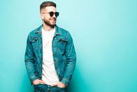 111 – Portrait of handsome smiling stylish hipster lambersexual model.Man dressed in jacket and jeans.