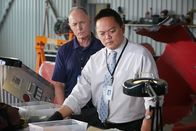 Mayday - Alarm im Cockpit – ONTARIO - RE-ENACTMENT - NTSC Investigator (played by Redd Ochao) finds something curious in the pieces obtained from the plane crash. The BEA agent (played by a background performer) stands by and observes.