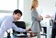 111 – Asian man playing a prank on his colleague in office