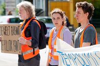 neoriginal: Aufgestaut – Die Aufregung steigt! Alle bereit? Lena (Valerie Stoll, M.) gibt das Kommando, woraufhin sich Henning (Joachim Seemann, l.) und Finn (Adrian Grünewald, r.) auf die Straße setzen sollen und ihre Hände auf den Asphalt kleben.