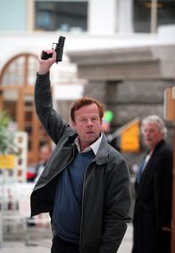 Mankells Wallander – Kommissar Wallander (Krister Henriksson, links) legt seine Waffe nieder, um sich gegen eine Geisel auszutauschen.