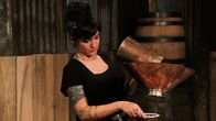 Moonshiners: Master Distiller – Mena working the still.