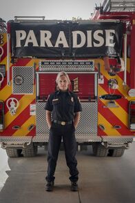 Rebuilding Paradise – Paradise, CA - Shawna Powell, Cal Fire Northern Region Peer Support Battalion Chief, stands in front of a Paradise Fire Department fire truck. (National Geographic/Sarah Soquel Morhaim)